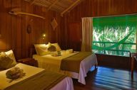 Rustic wooden cabin with twin beds and jungle views at Ecopark Jungle Lodge in the Brazilian Amazon near Manaus. 