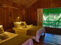 Rustic wooden cabin with twin beds and jungle views at Ecopark Jungle Lodge in the Brazilian Amazon near Manaus. 