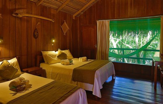 Rustic wooden cabin with twin beds and jungle views at Ecopark Jungle Lodge in the Brazilian Amazon near Manaus. 