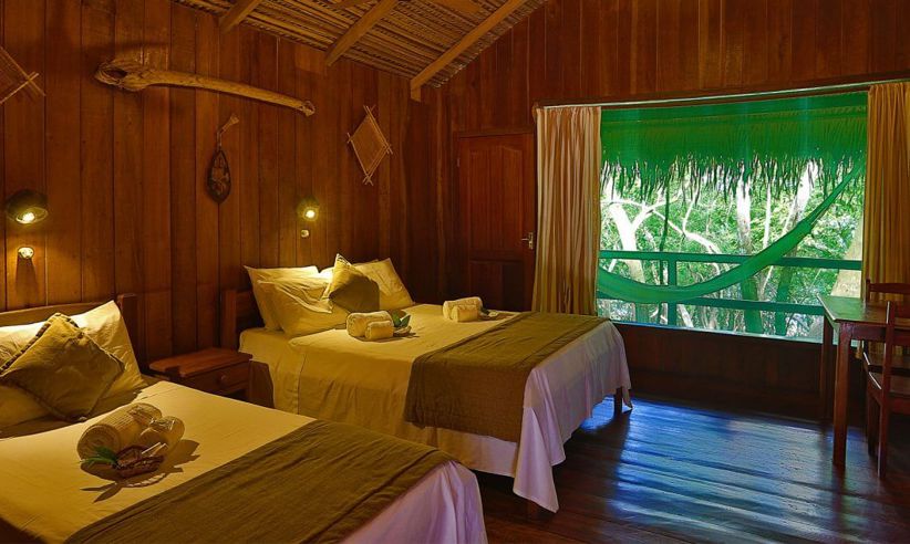 Rustic wooden cabin with twin beds and jungle views at Ecopark Jungle Lodge in the Brazilian Amazon near Manaus. 