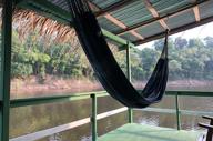 Relaxing hammock with river views at Eco Park Jungle Lodge, nestled in the Amazon Rainforest near Manaus, Brazil. 