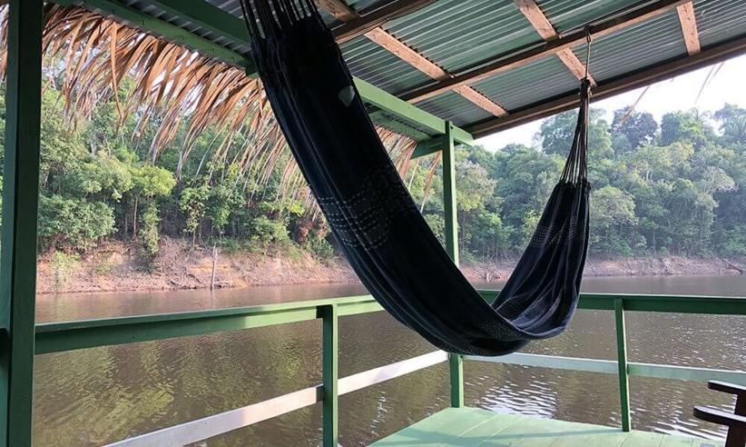 Relaxing hammock with river views at Eco Park Jungle Lodge, nestled in the Amazon Rainforest near Manaus, Brazil. 