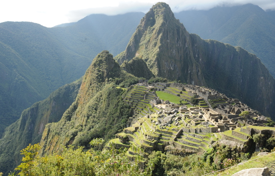 The ancient Inca city of Machu Picchu unfolds beneath towering peaks and a misty Andean sky.