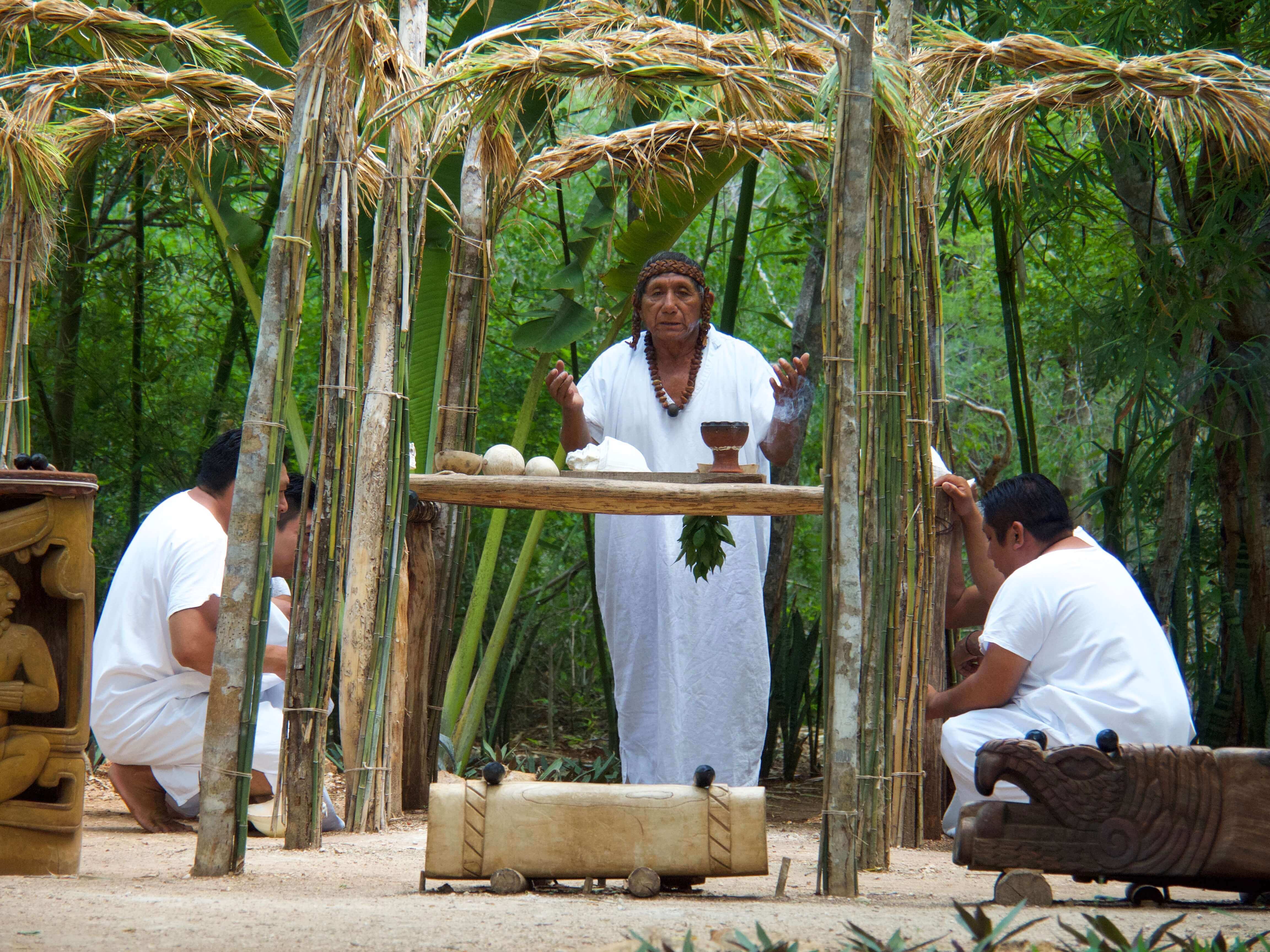 Mayan ritual performed in the Yucatan jungle with traditional attire, natural altar, and sacred elements. 