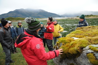 Expert-led nature walk in Tierra del Fuego, exploring moss-covered rocks and southern Patagonian landscapes. 