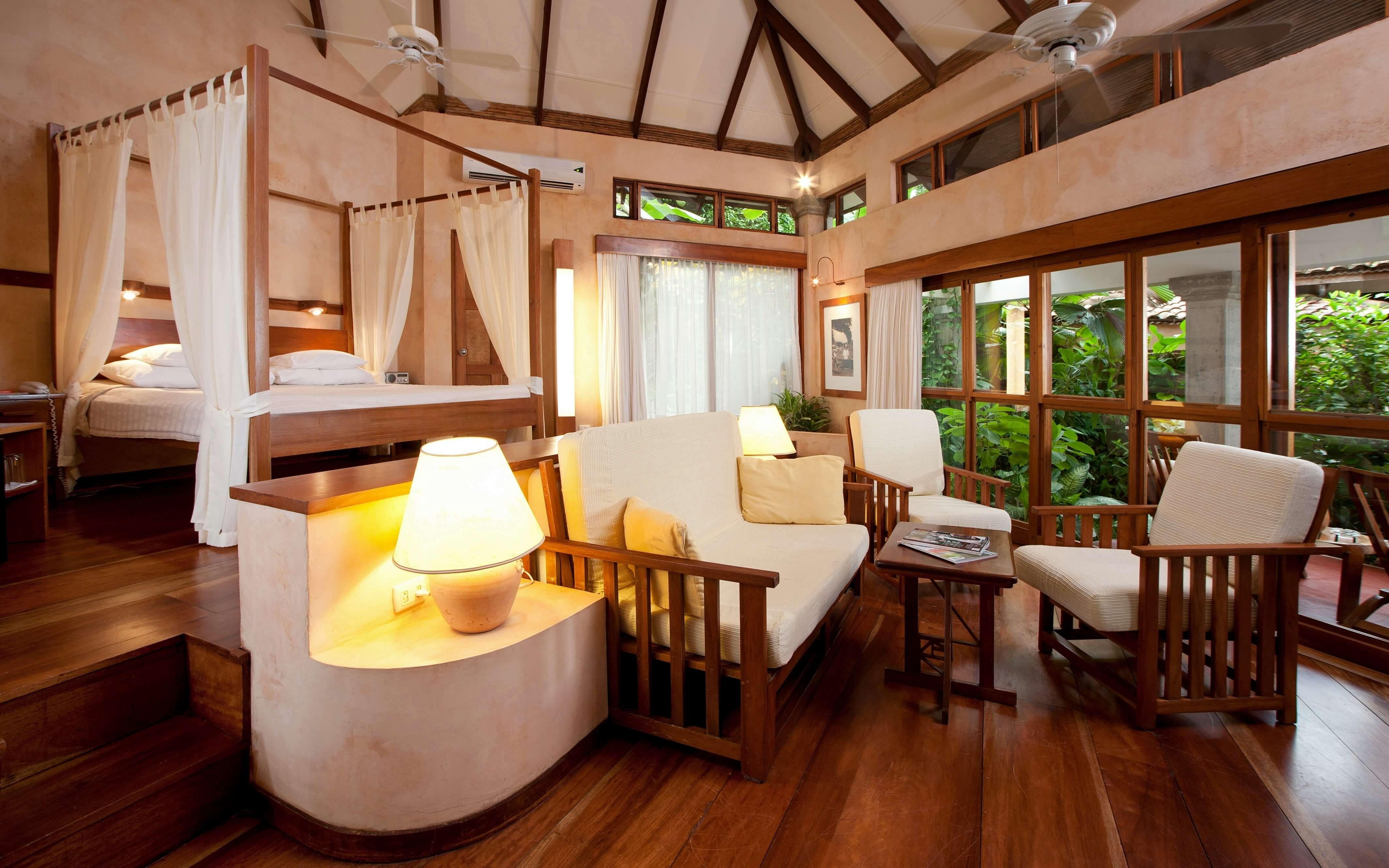 A warm, elegant suite at Capitan Suizo blends open-air luxury with natural Costa Rican style. 