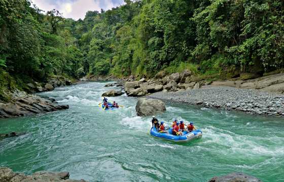 White-water rafting on the Pacuare River through lush rainforest in Costa Rica. 