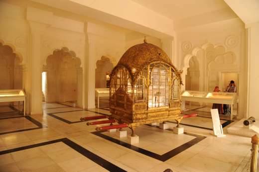 Asia, India - Ornate golden palanquin displayed in the City Palace Museum, Rajasthan. 