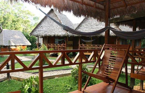 Relaxing hammock terrace overlooking jungle lodges in Tambopata, Peru. 