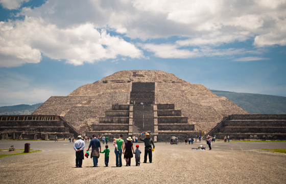 Tourists at the Pyramid of the Moon in Teotihuacan, Mexico under a dramatic skies at this ancient Mesoamerican site.