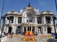 Palacio de Bellas Artes in Mexico City with Day of the Dead altar and colourful  marigold decorations in front of the entrance. 
