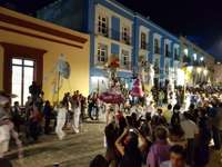 Vibrant Day of the Dead parade in Oaxaca, Mexico with giant skeleton puppets, dancers, and colourful street decorations. 