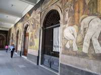 Famous Diego Rivera murals on the walls of the National Palace in Mexico City, depicting Mexican history and labor scenes. 