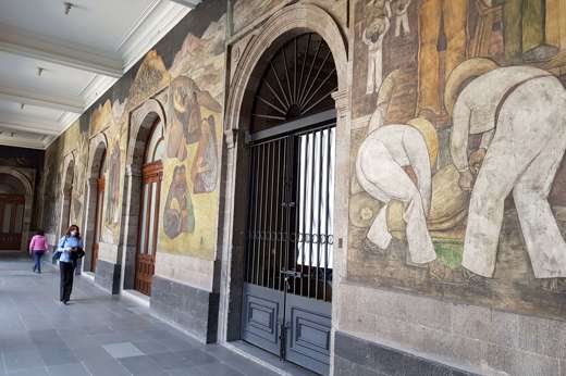 Famous Diego Rivera murals on the walls of the National Palace in Mexico City, depicting Mexican history and labor scenes. 