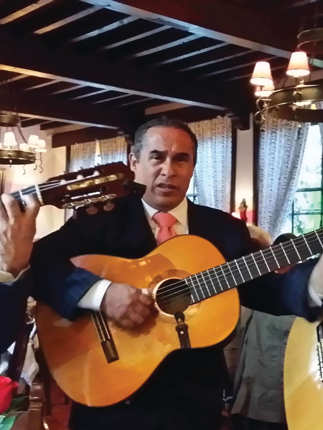 Three traditional Mexican guitarists perform indoors, capturing the spirit and musical heritage of Mexico. 