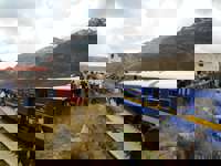 Passengers at La Raya Pass, a high-altitude stop on the Belmond Andean Explorer train route. 