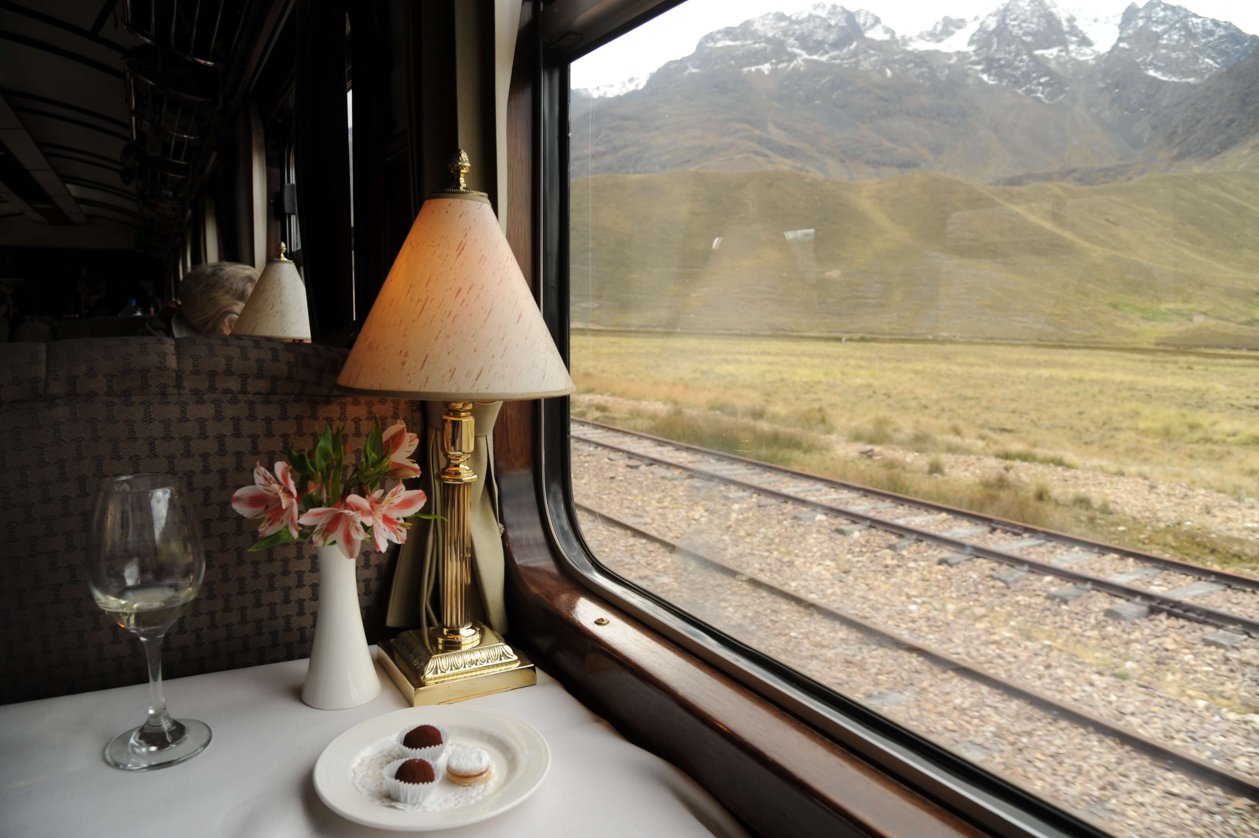 Refined table setting aboard the Belmond Andean Explorer, offering panoramic views of the Peruvian Andes during the journey. 