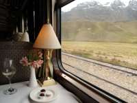 Refined table setting aboard the Belmond Andean Explorer, offering panoramic views of the Peruvian Andes during the journey. 
