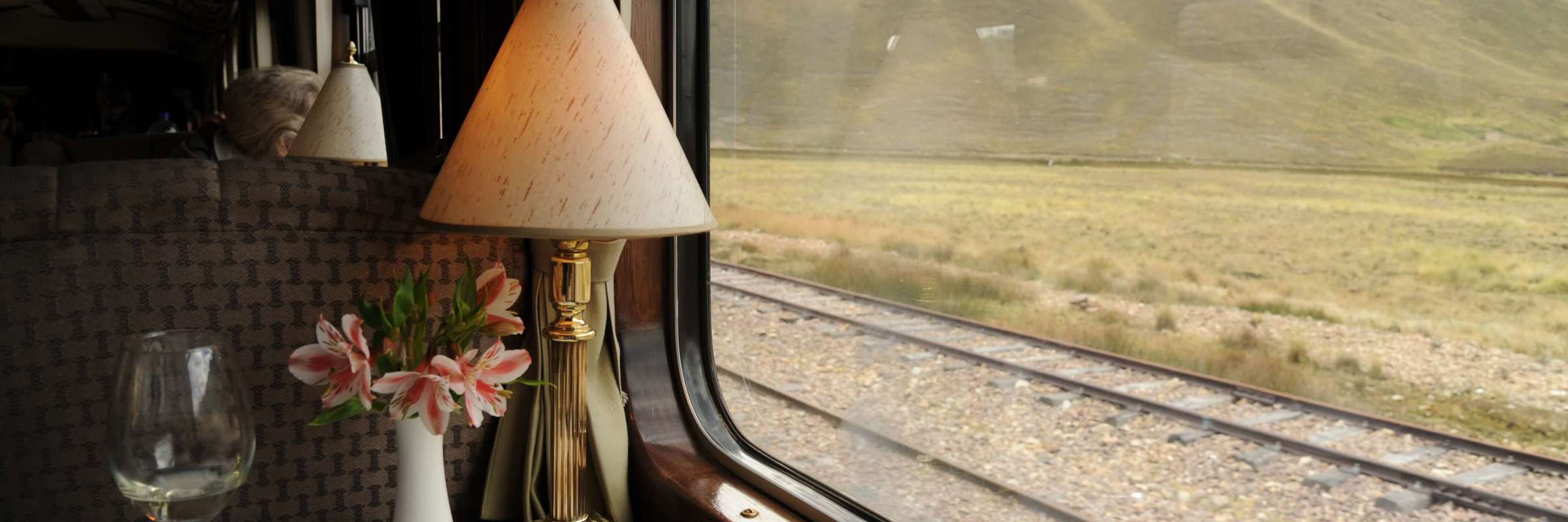 Refined table setting aboard the Belmond Andean Explorer, offering panoramic views of the Peruvian Andes during the journey. 
