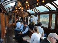 Guests enjoying the panoramic observation lounge aboard the Belmond Andean Explorer train. 