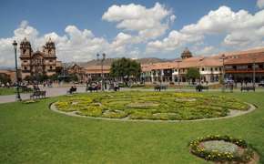 Cusco's Plaza de Armas glows under Andean skies, with vibrant gardens and colonial architecture all around. 