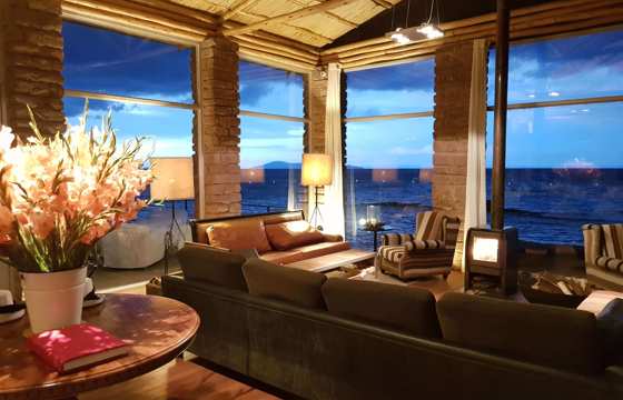 South America - Peru, stylish interior lounge of Titilaka Lodge overlooking Lake Titicaca. 