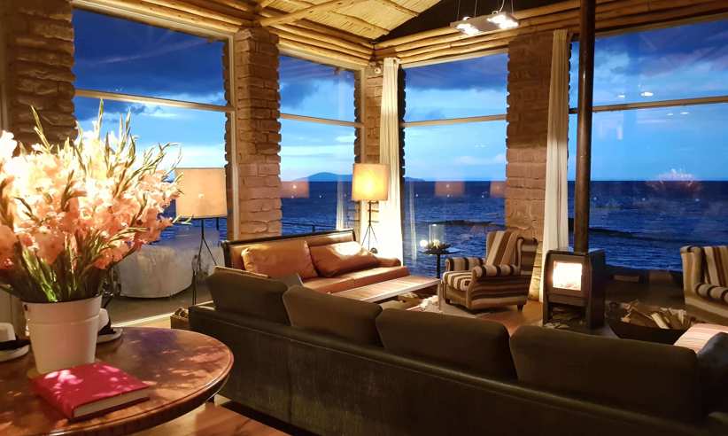 South America - Peru, stylish interior lounge of Titilaka Lodge overlooking Lake Titicaca. 