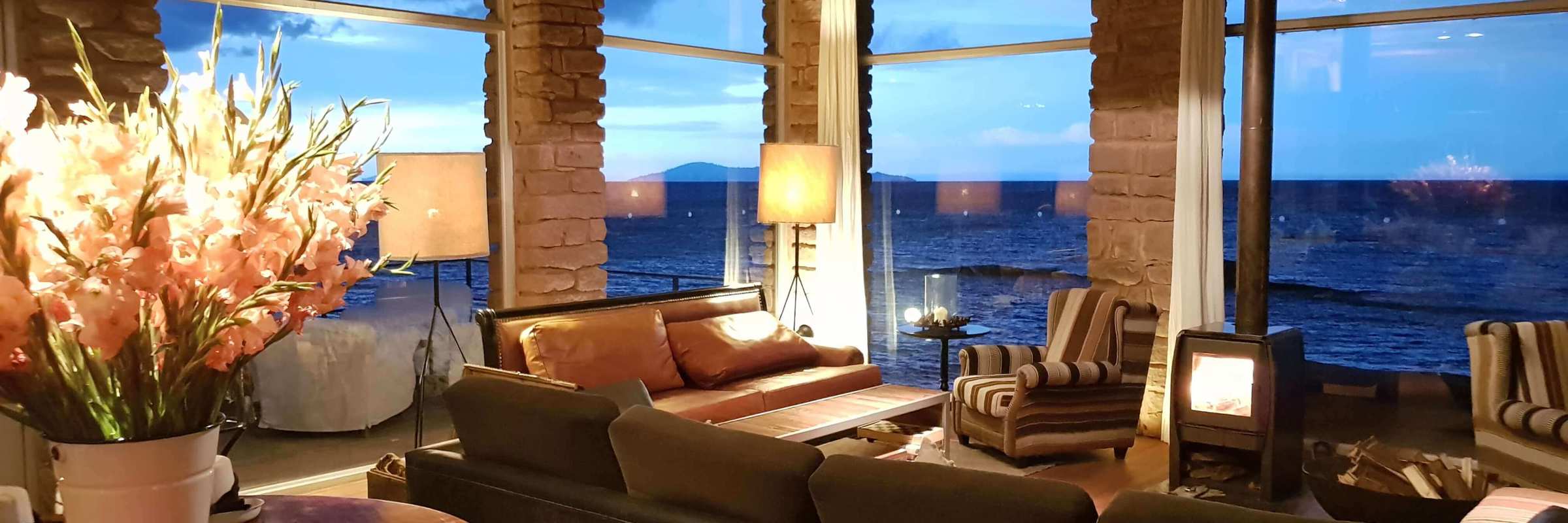 South America - Peru, stylish interior lounge of Titilaka Lodge overlooking Lake Titicaca. 