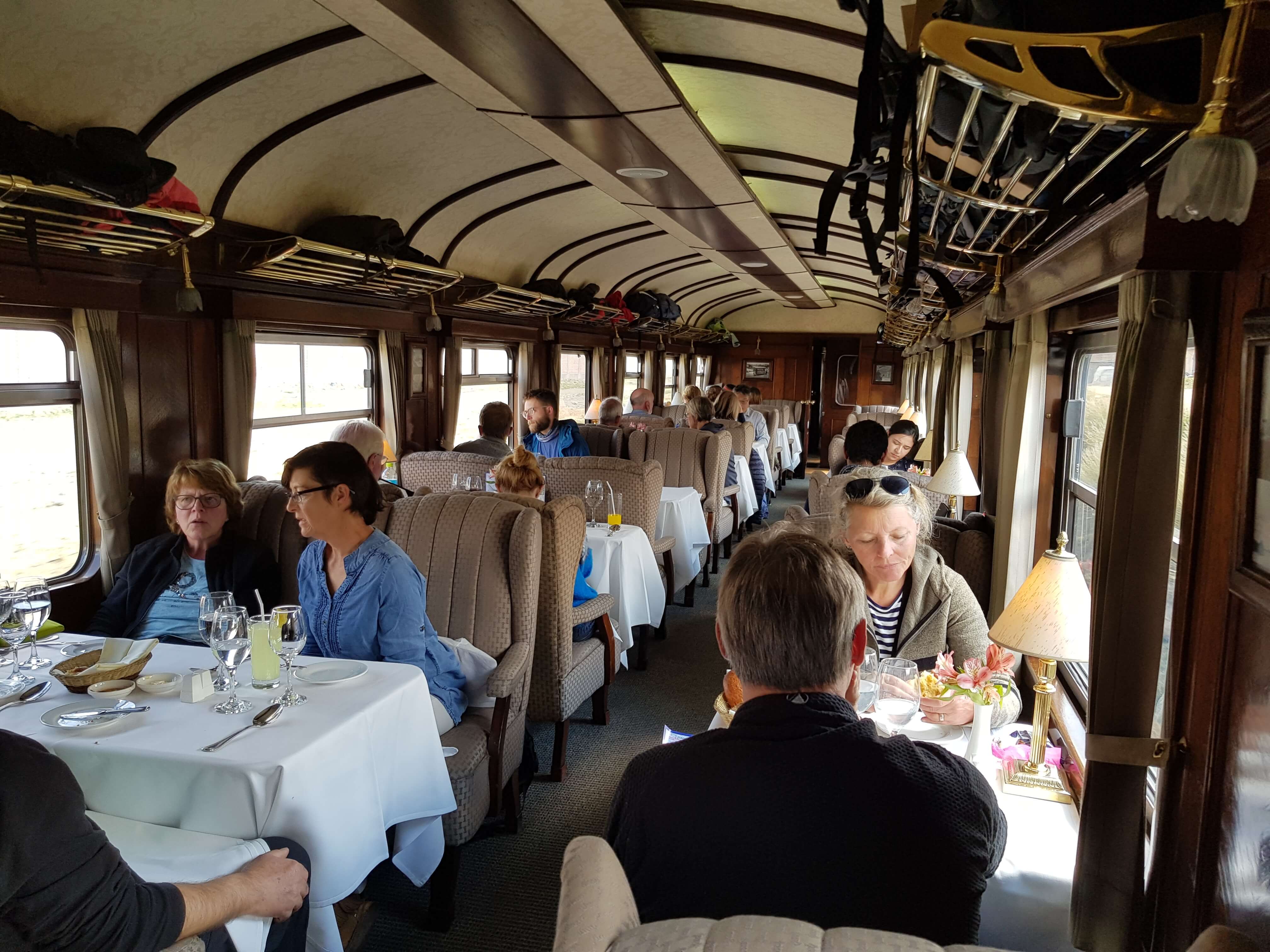 Travelers dining aboard the Andean Explorer luxury train en route through scenic Peru. 