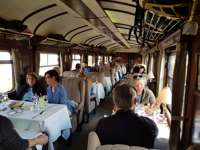 Travelers dining aboard the Andean Explorer luxury train en route through scenic Peru. 