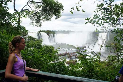 Viewpoint over Iguassu Falls in Brazil, framed by tropical rainforest and mist. 