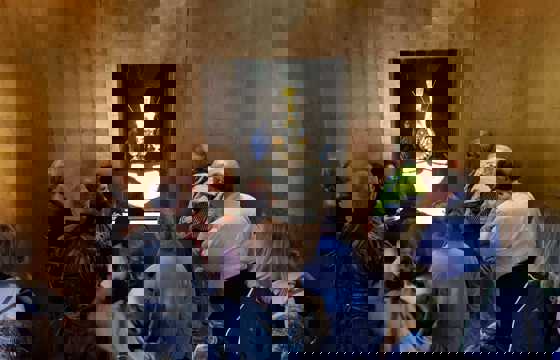 Tourists viewing an ancient golden mask exhibit in a museum in Lima, Peru. 