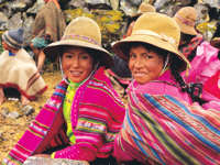 Smiling Peruvian girls in colourful traditional clothing, Sacred Valley Cultural Heritage. 