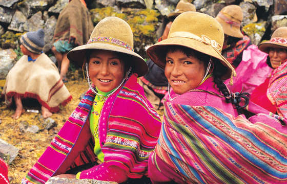 Smiling Peruvian girls in colourful traditional clothing, Sacred Valley Cultural Heritage. 