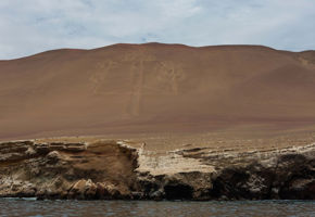 Paracas Candelabra geoglyph etched into the coastal hillside, viewed from the sea near the Ballestas Islands in Peru. 