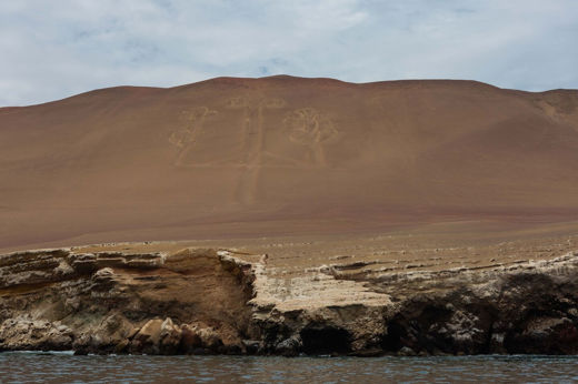 Paracas Candelabra geoglyph etched into the coastal hillside, viewed from the sea near the Ballestas Islands in Peru. 