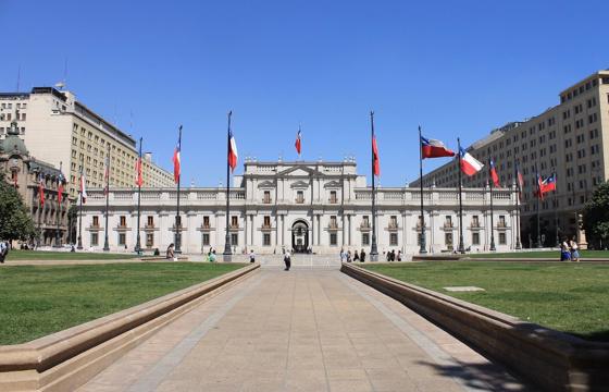 La Moneda  Palace, Chile's presidential residence, stands proudly in central Santiago surrounded by flags and formal gardens. 