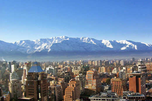 Snow-covered Andes towering above Santiago's urban skyline on a crisp winter day in central Chile. 