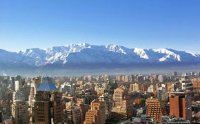 Snow-covered Andes towering above Santiago's urban skyline on a crisp winter day in central Chile. 