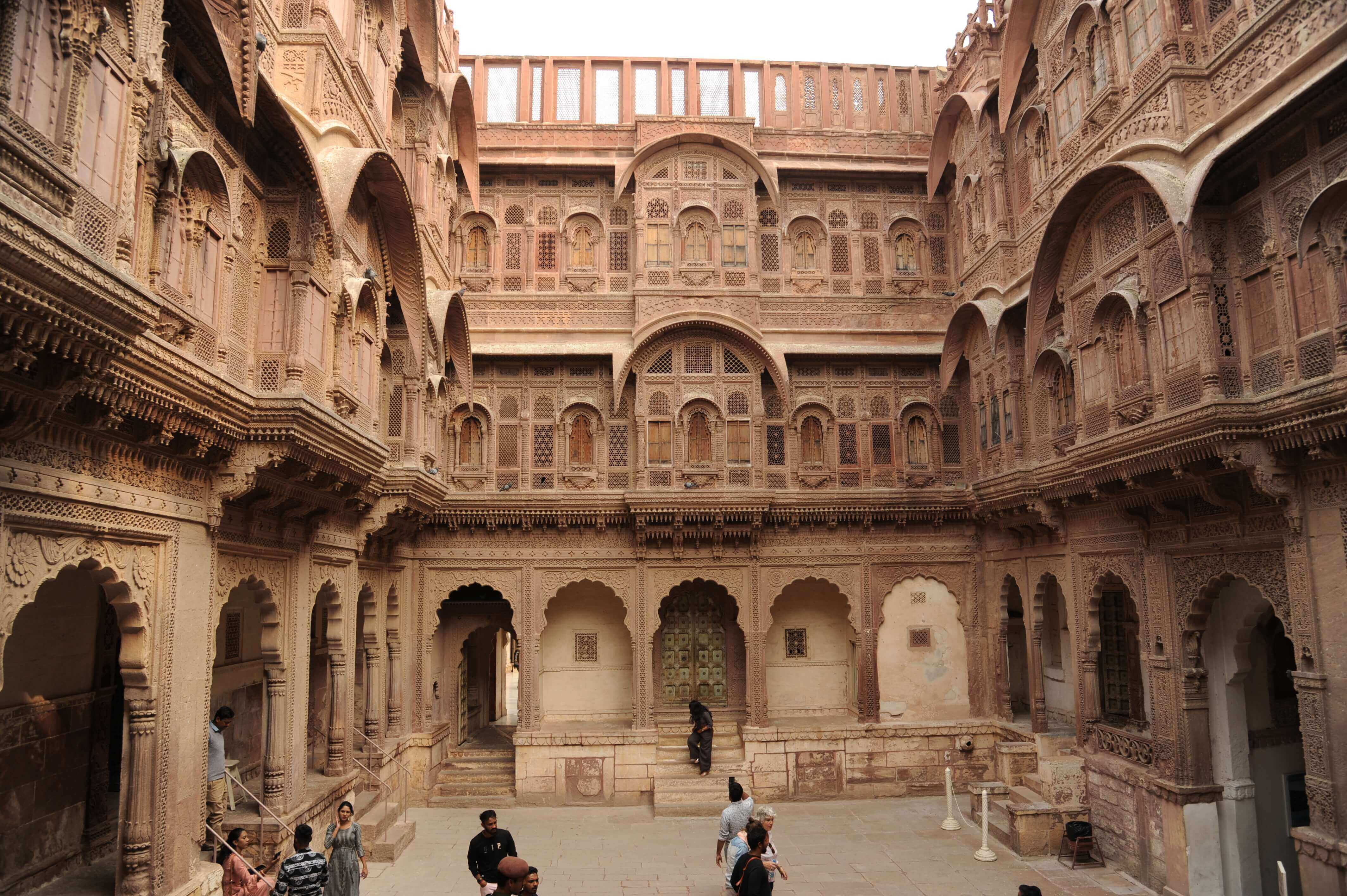 Asia-India - Tourists explore the intricate inner courtyard of Mehrangarh Fort in Jodhpur. 