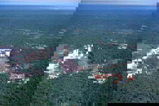 Aerial view of Brazil's Iguassu Falls and rainforest lodges nestled nearby. 