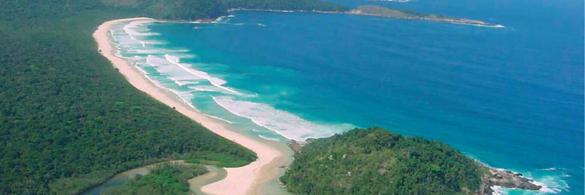 Aerial view of sweeping beaches and forested coastline on Ilha Grande.