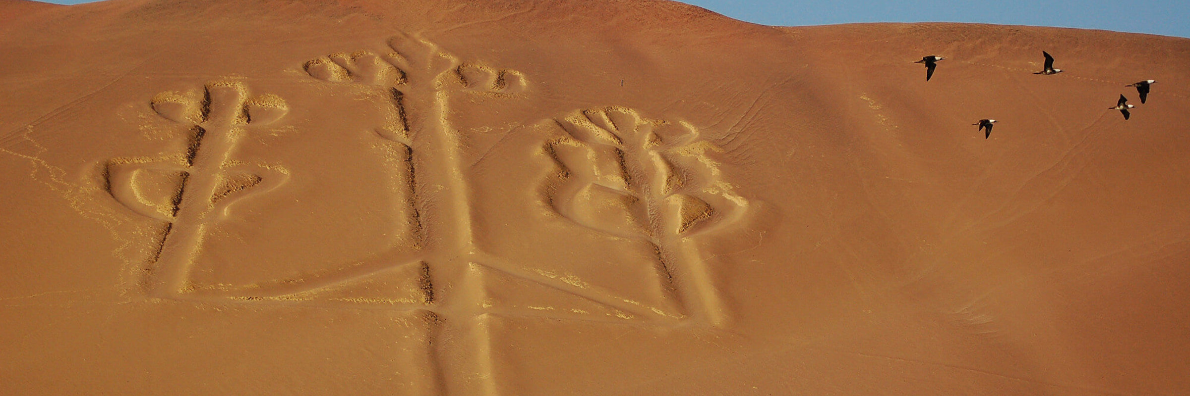The Paracas Candelabra geoglyph carved into the coastal desert hillside near Paracas, Peru. 