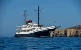 The Evolution sailing past Isabela Island