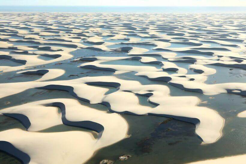 Aerial view of the Lencois Maranhenses' vast sand dunes and crystal-clear lagoons in northeastern Brazil. 