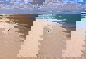 Vast sand dunes at Duna do Por do Sol in Jericoacoara, Ceara, Brazil, with ocean views and ridge.  