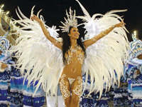 Samba queen in feathered costume leading Rocinha school at Rio Carnival parade, Brazil. 