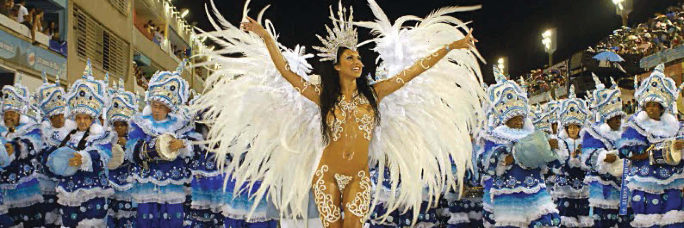 Samba queen in feathered costume leading Rocinha school at Rio Carnival parade, Brazil. 