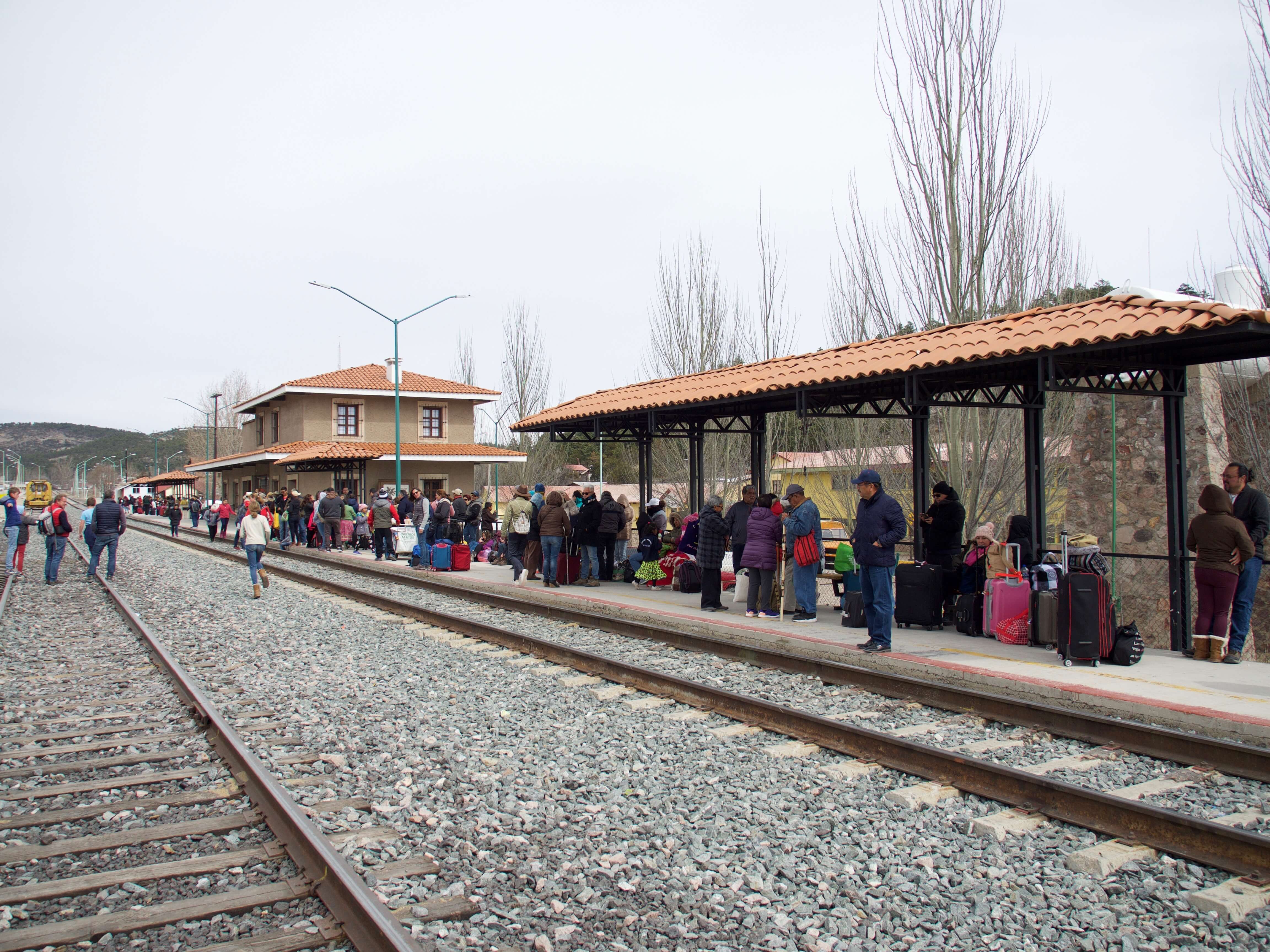 Passengers waiting at the Chepe train station in Copper Canyon, Mexico, ready for the scenic rail journey through the canyon. 