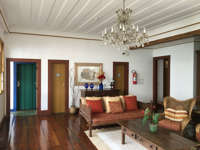 Charming colonial-style hotel lobby with wooden floors, vintage decor, and chandelier in Minas Gerais, Brazil. 